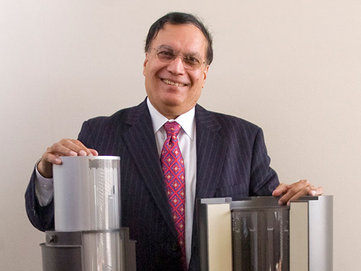 Engineer and inventor Kris Singh, President and CEO of Holtec International of Marlton, stands next to models of his inventions: nuclear waste storage containers. ( Clem Murray / Staff Photographer )